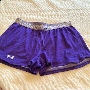 Purple Under Armour athletic shorts.
